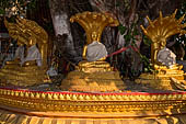 Vientiane, Laos - Pha That Luang, among the other structures on the ground there is a circular platform surrounding a large Bodhi tree contains Buddha images in several mudras.  